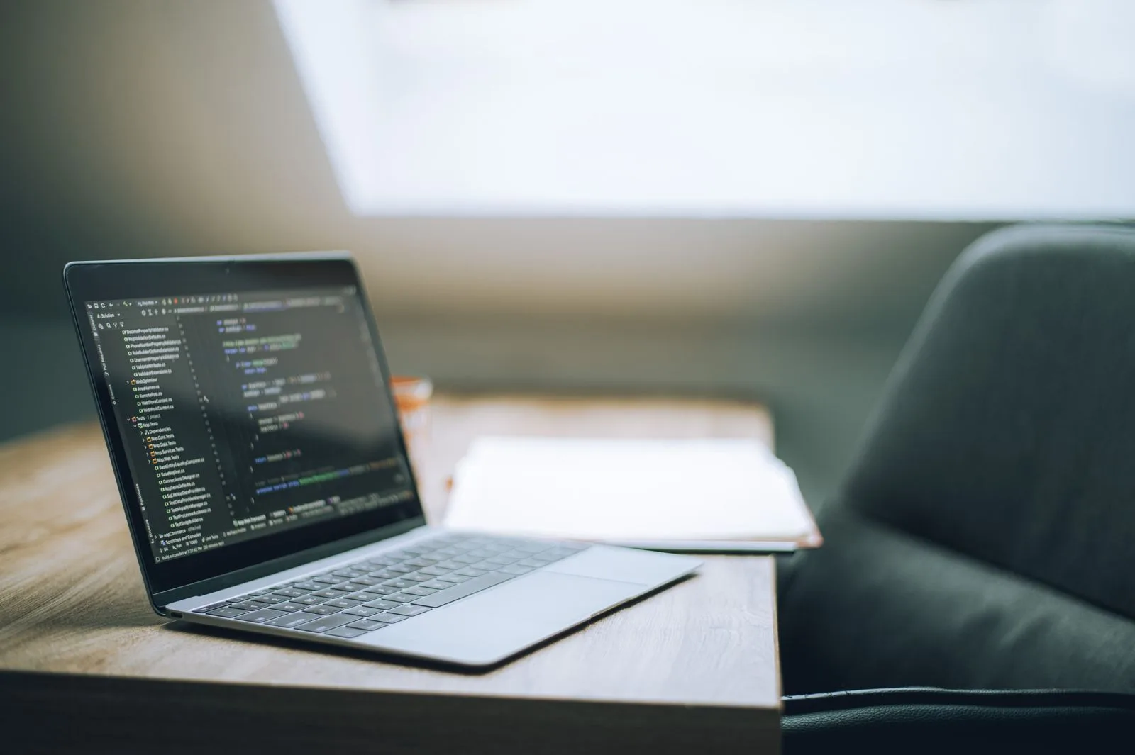 A modern workspace with a laptop displaying lines of code