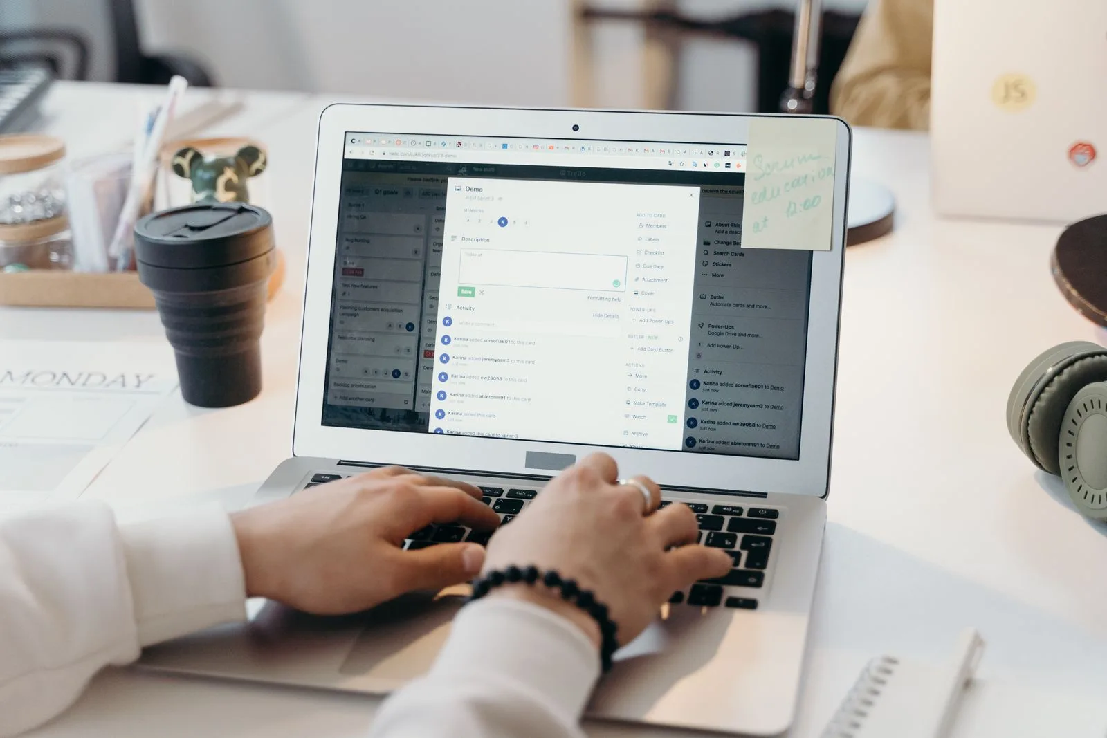 A person reviewing a document on a laptop in a modern office setting