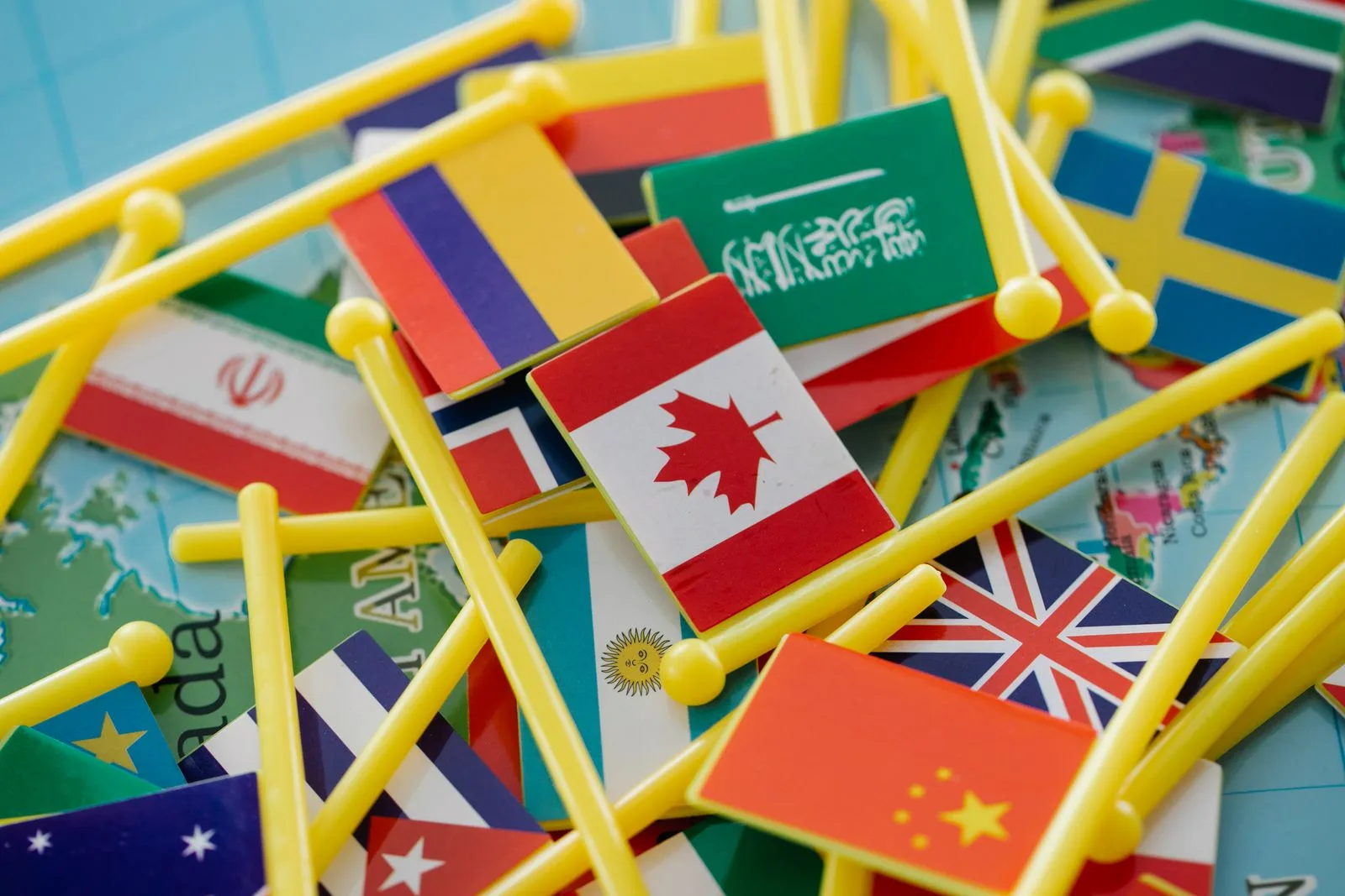 Colorful mini flags of different countries arranged on a world map