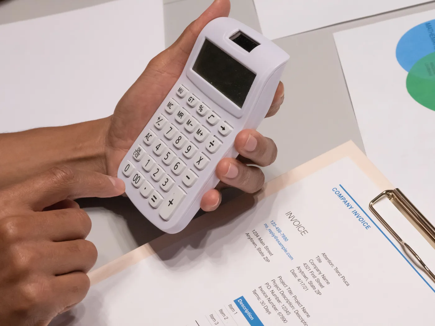 Calculator and financial documents on a desk representing software project cost analysis