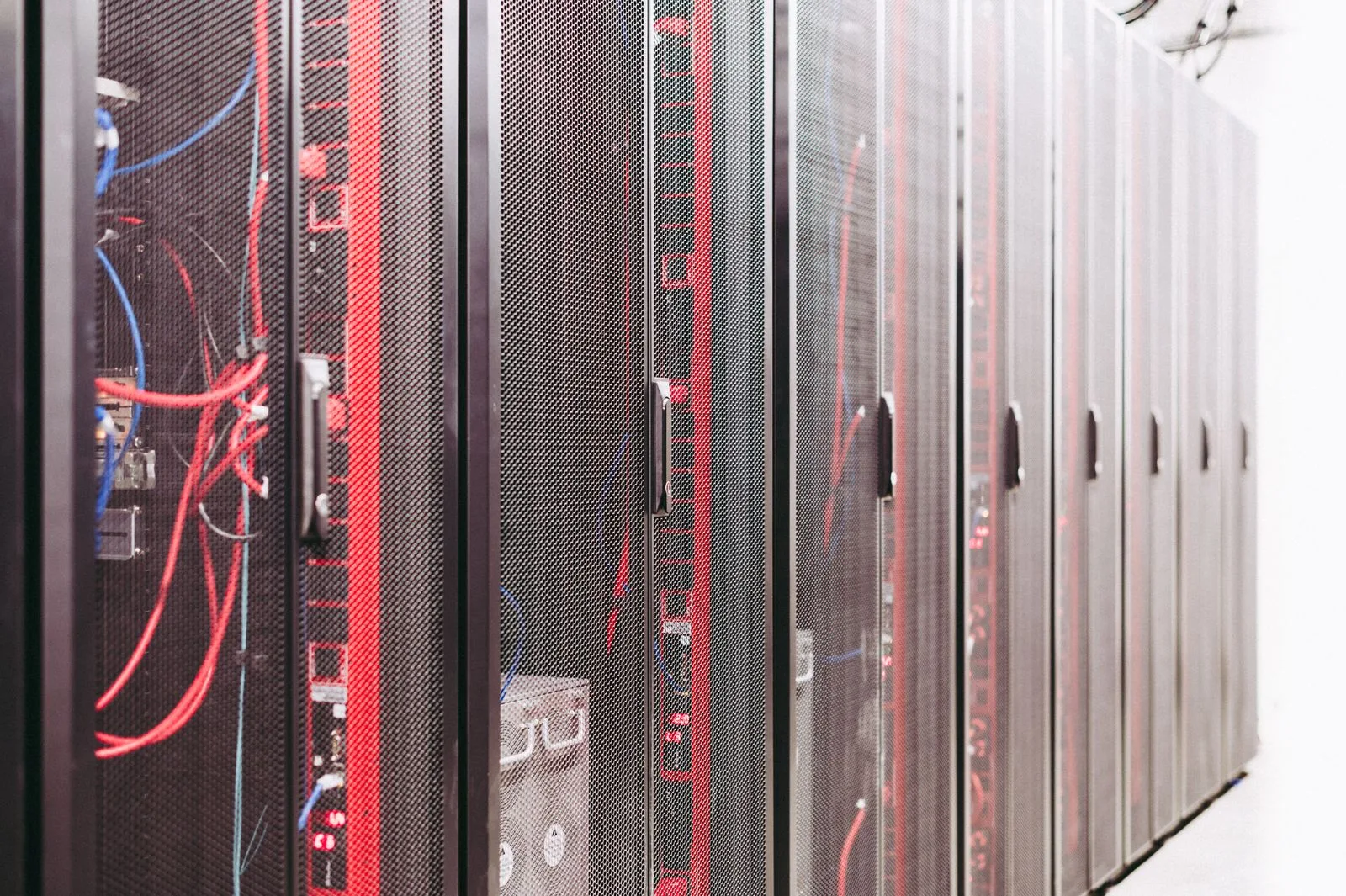 Server room wiring managing centralized data access, representing backup and disaster recovery infrastructure