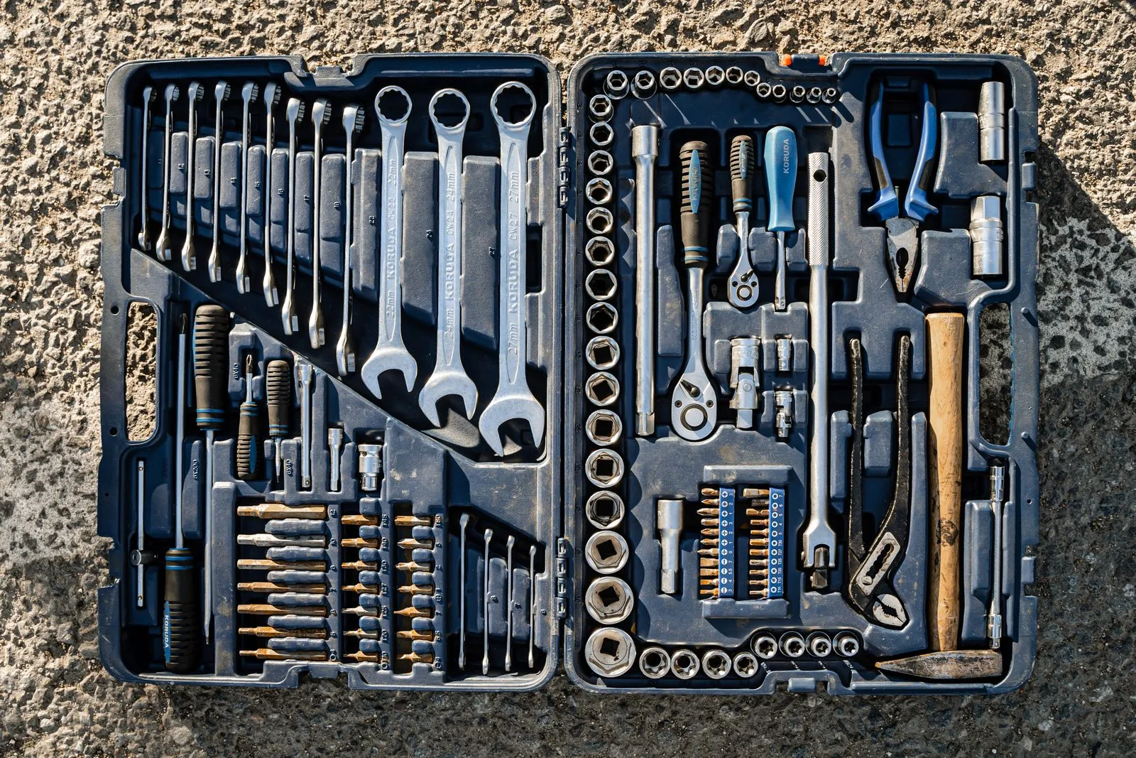 A flat lay of an organized toolbox with a variety of essential hand tools