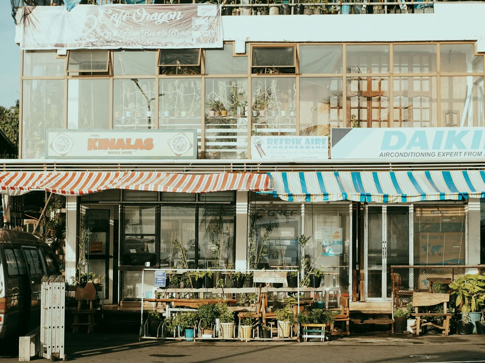 A charming street scene with several small local shopfronts side by side