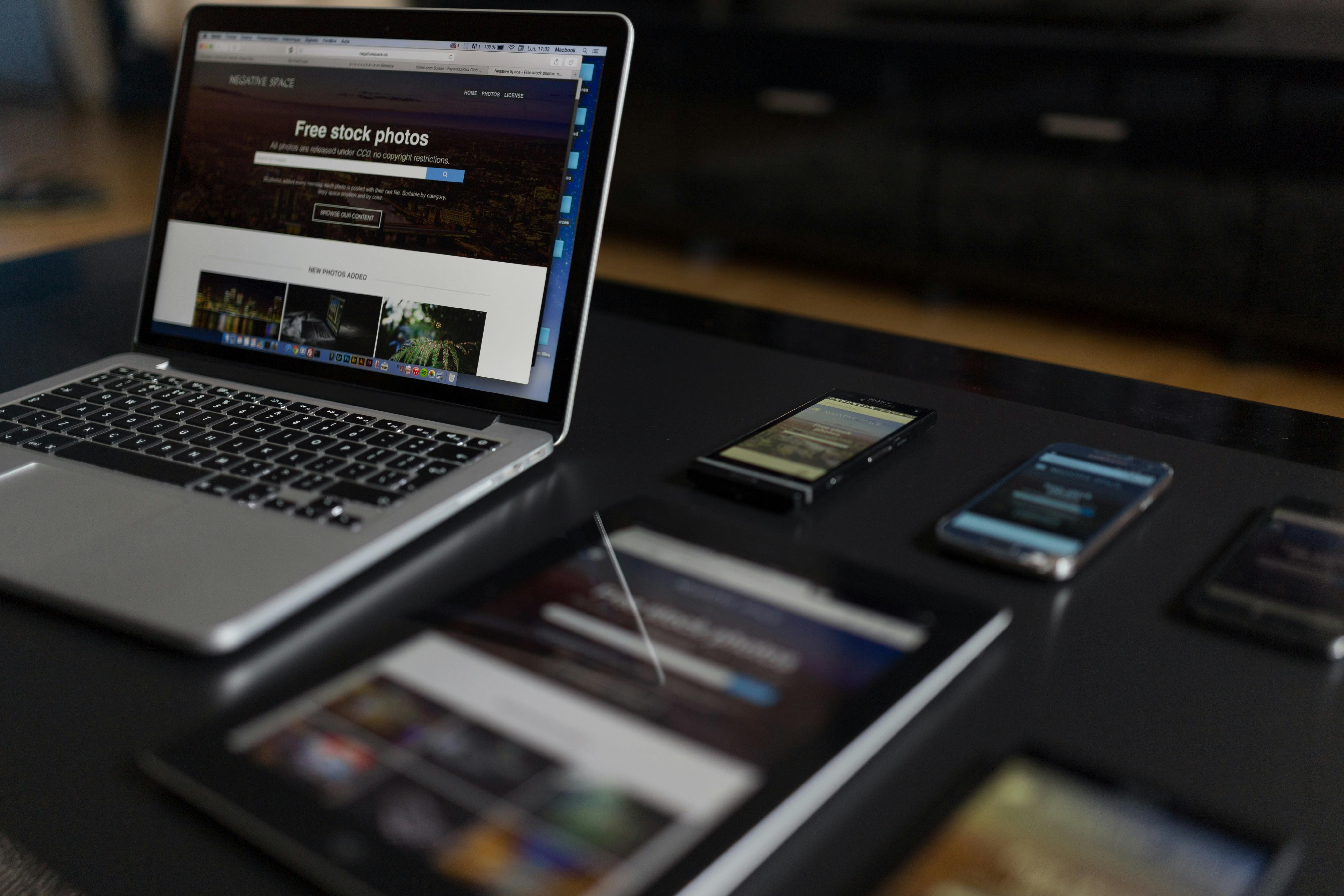 Modern workspace with laptop, tablet, and smartphones on a desk — representing digital business tools