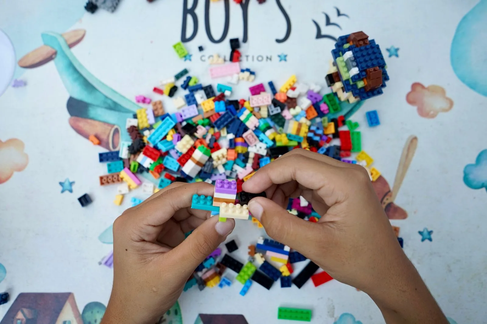 A child's hands assembling colorful building blocks together, representing software components