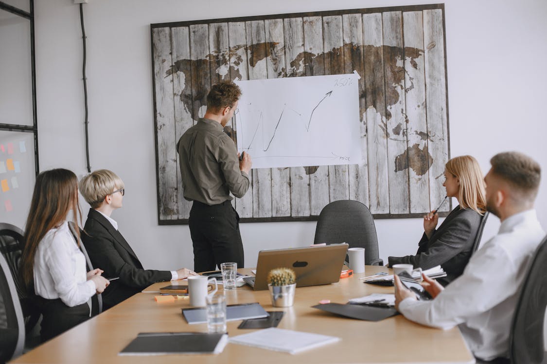 Business professionals discussing strategies with a growth chart in a conference room