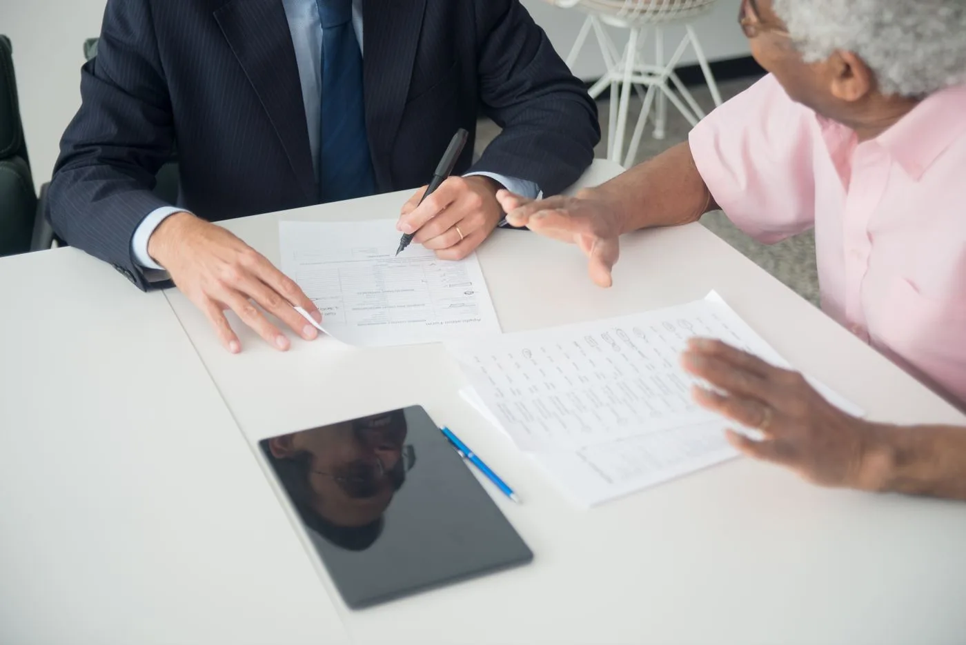 Professional in a business meeting presenting technical concepts to executives at a conference table