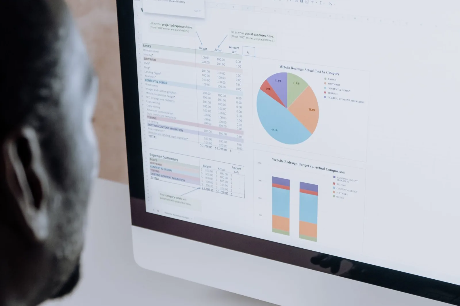 A spreadsheet open next to a business management software dashboard on the same screen