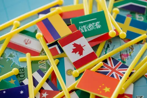 Colorful mini flags of different countries arranged on a world map