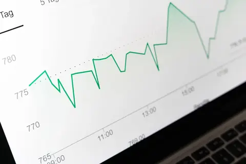 Financial graph displayed on a laptop screen, representing cloud cost analysis and optimization