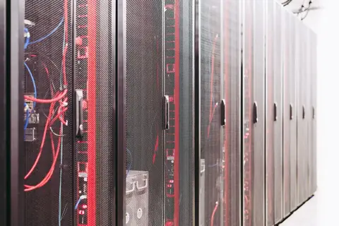 Server room wiring managing centralized data access, representing backup and disaster recovery infrastructure
