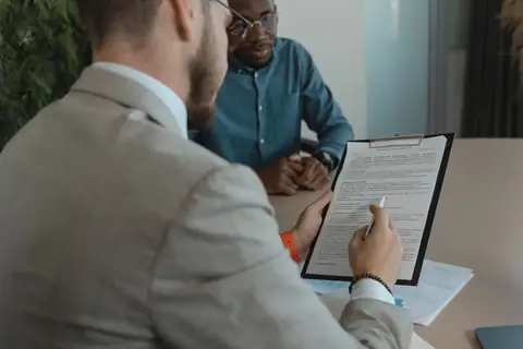 Hiring manager reviewing a short stack of job applications