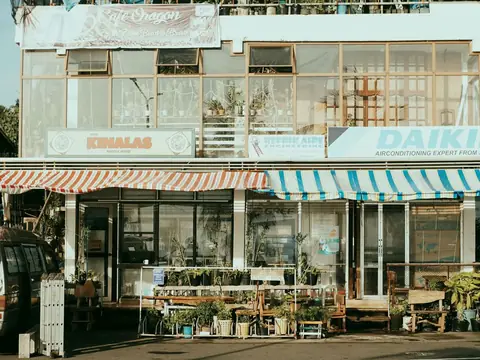 A charming street scene with several small local shopfronts side by side