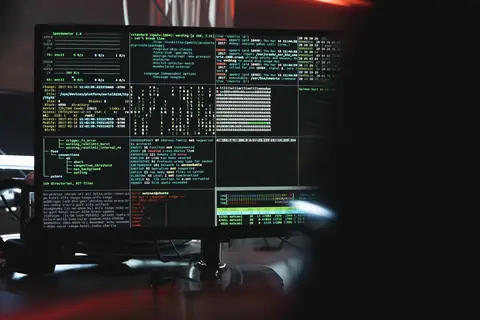 Two computer screens side by side showing code, representing a comparison between Node.js and .NET backend development
