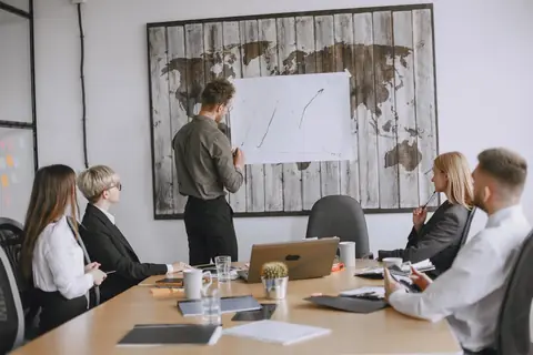 Business professionals discussing strategies with a growth chart in a conference room