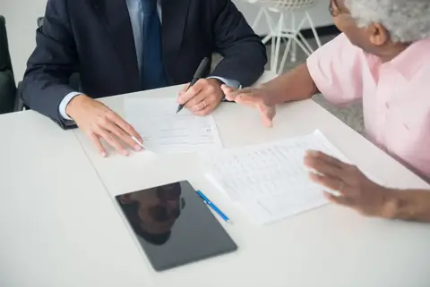 Professional in a business meeting presenting technical concepts to executives at a conference table