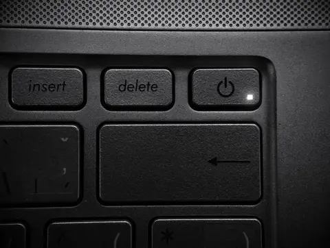 Close-up of a laptop keyboard highlighting the power and delete keys