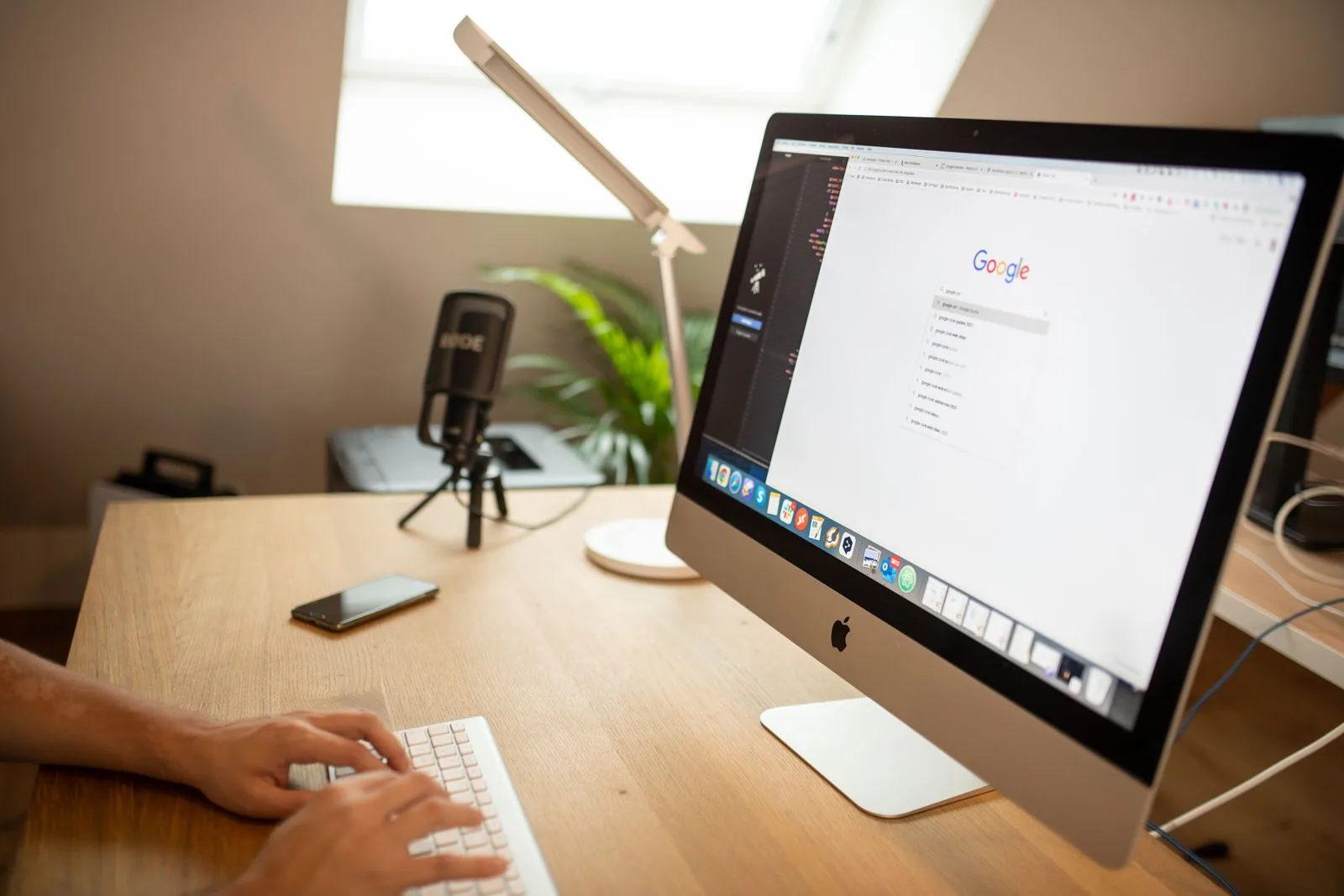 A modern workspace with a desktop computer displaying a search interface